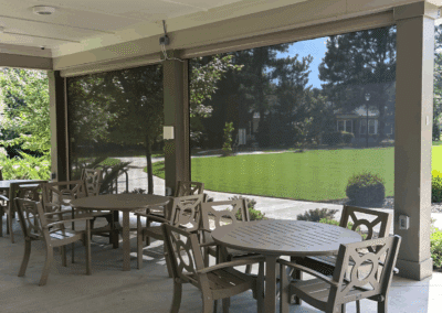 Exterior shades filtering in natural light to an outdoor seating area.