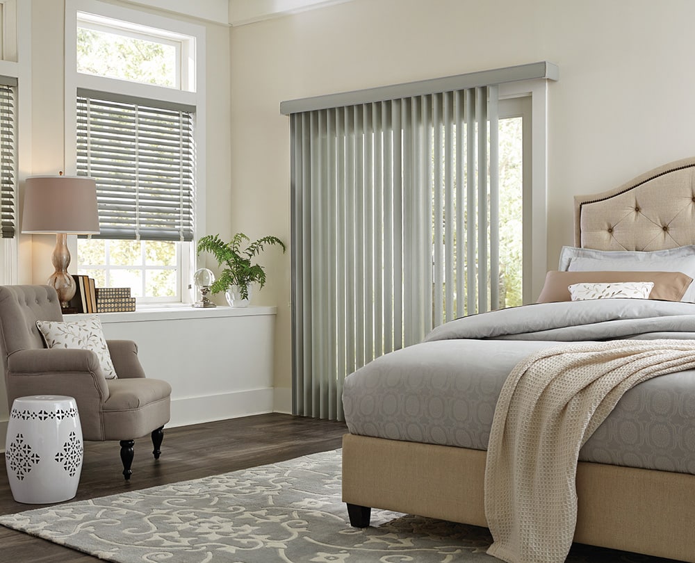 Vertical Blinds filtering in light in a master bedroom.