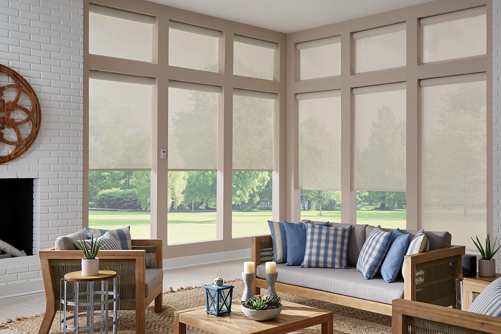 Twelve panels of solar shades filtering in light into a beautiful living room.